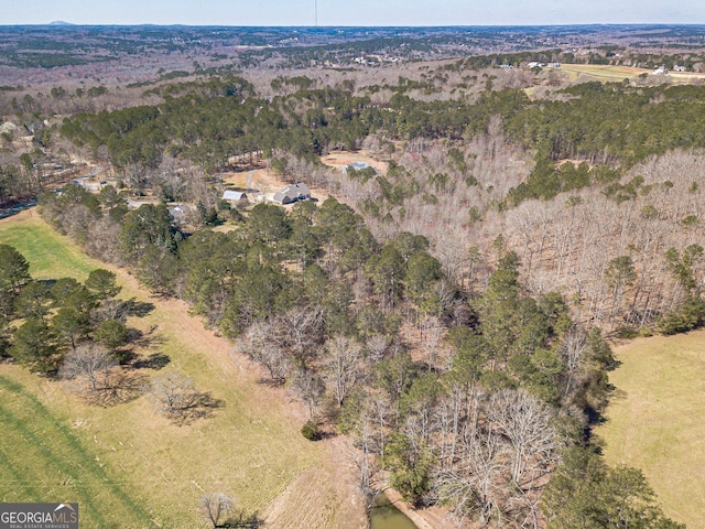 birds eye view of property with a forest view