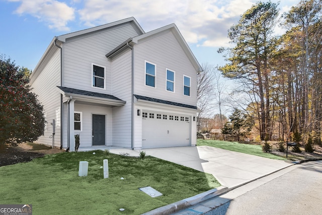 traditional-style home with a garage, concrete driveway, and a front lawn