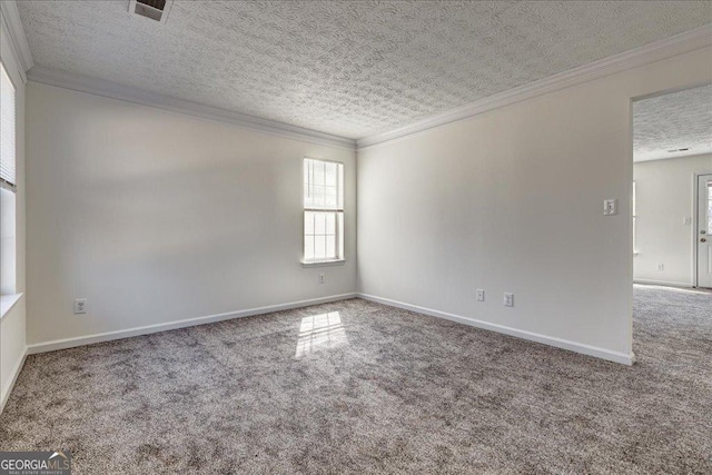 carpeted spare room with a textured ceiling, ornamental molding, and baseboards