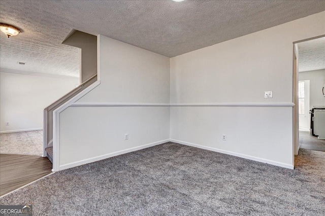 interior space featuring a textured ceiling, stairs, baseboards, and carpet flooring