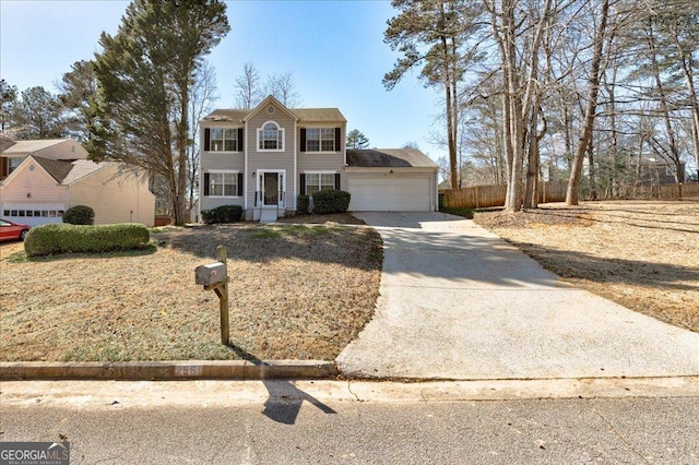 view of front facade with an attached garage, fence, and concrete driveway