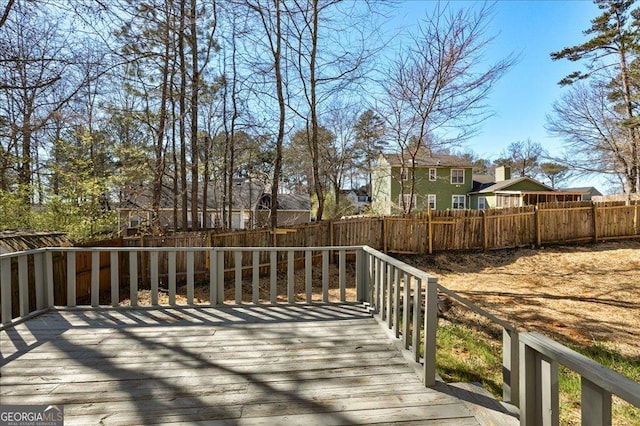 wooden terrace featuring a fenced backyard