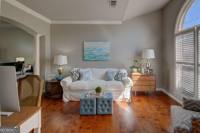 living area with arched walkways, crown molding, ornate columns, visible vents, and hardwood / wood-style floors