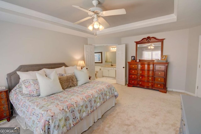 bedroom with a tray ceiling, light carpet, crown molding, and baseboards