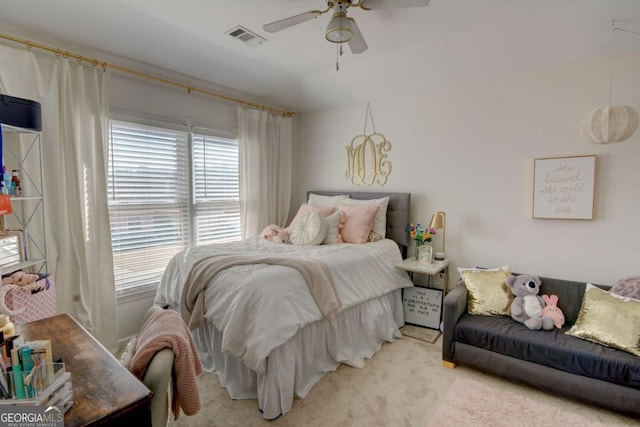 bedroom featuring ceiling fan, visible vents, and light colored carpet