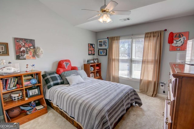 bedroom with light carpet, ceiling fan, visible vents, and baseboards