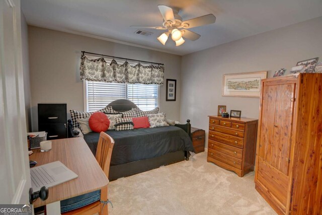 bedroom with light carpet, ceiling fan, and visible vents