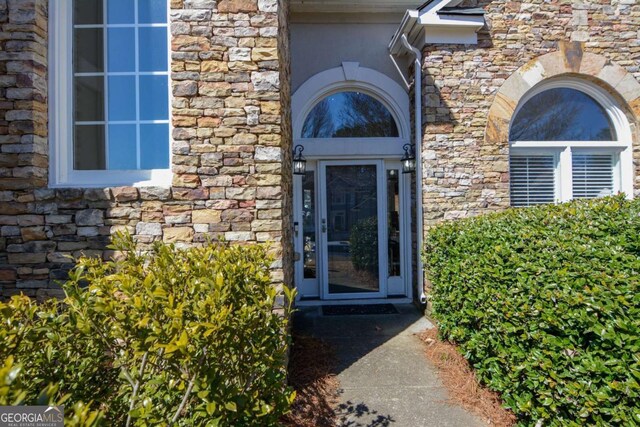 property entrance with stone siding