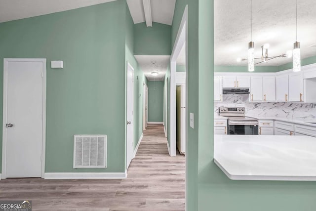 kitchen featuring visible vents, electric range, light wood-style floors, white cabinetry, and under cabinet range hood