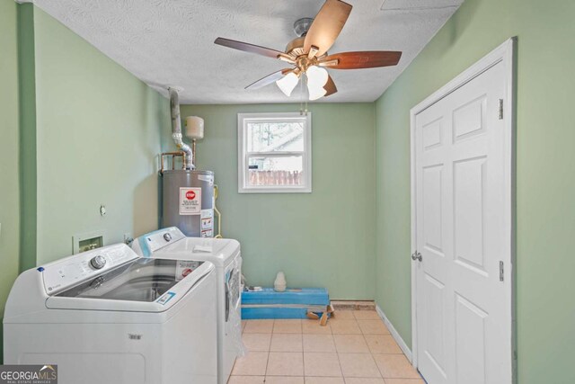 clothes washing area featuring laundry area, a ceiling fan, a textured ceiling, separate washer and dryer, and gas water heater