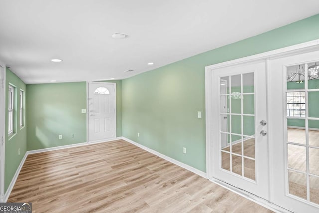 foyer featuring french doors, recessed lighting, wood finished floors, and baseboards