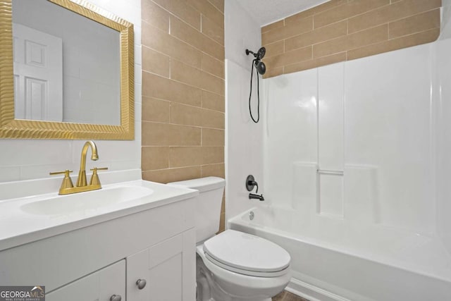 full bathroom featuring toilet, shower / bathing tub combination, tile walls, and vanity