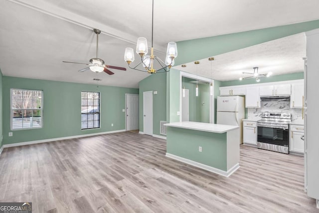 kitchen with electric stove, freestanding refrigerator, white cabinetry, under cabinet range hood, and baseboards