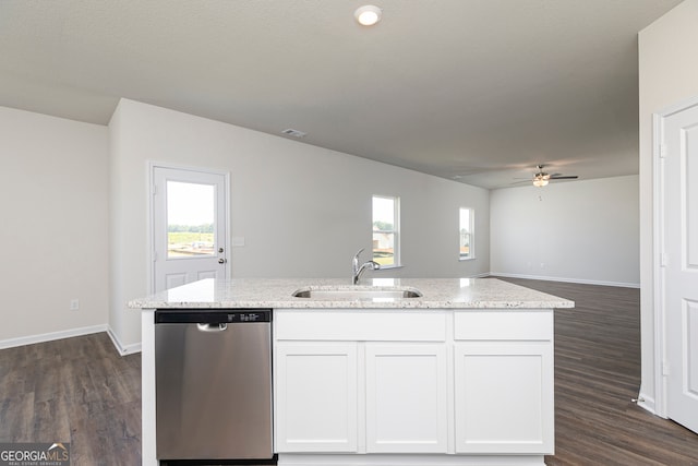 kitchen featuring light stone counters, dark wood finished floors, stainless steel dishwasher, white cabinets, and a sink