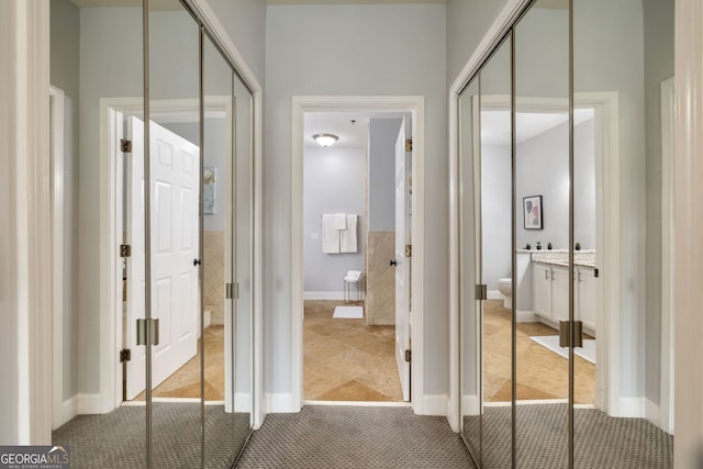 interior space with vanity, toilet, and tile patterned floors