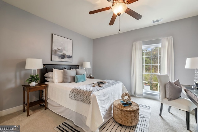 bedroom featuring light carpet, baseboards, visible vents, and a ceiling fan