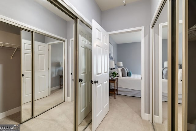 corridor with light carpet and baseboards