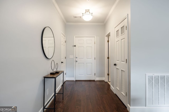 interior space featuring baseboards, dark wood-type flooring, visible vents, and crown molding