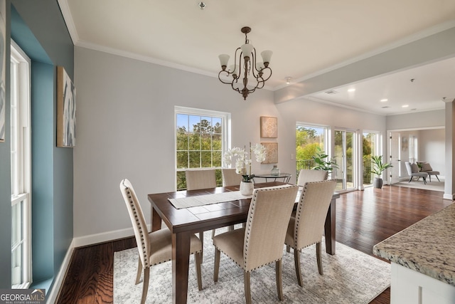 dining area featuring baseboards, a notable chandelier, dark wood finished floors, and a healthy amount of sunlight