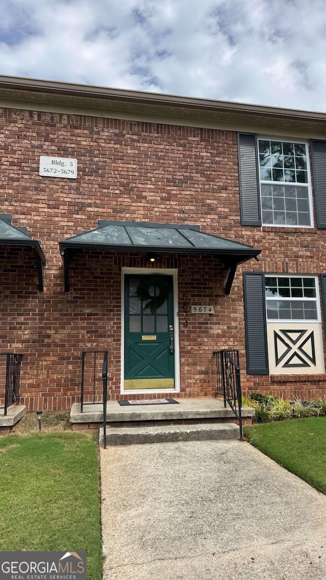 property entrance with brick siding