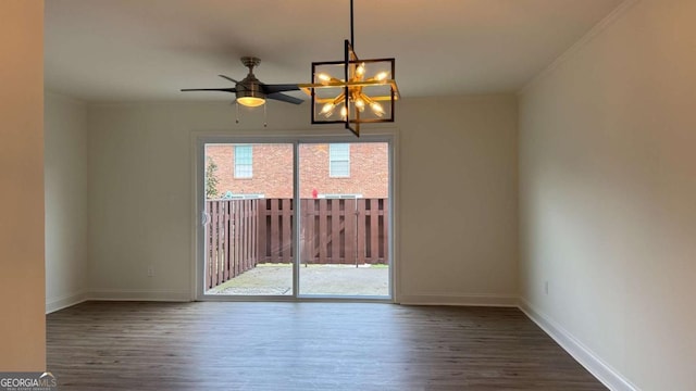 unfurnished room featuring an inviting chandelier, baseboards, and wood finished floors