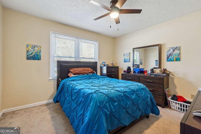 bedroom featuring carpet, baseboards, ceiling fan, and a textured ceiling