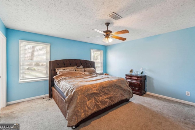 carpeted bedroom featuring multiple windows, visible vents, and baseboards