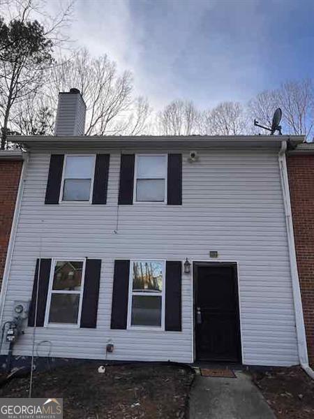 view of front facade featuring a chimney