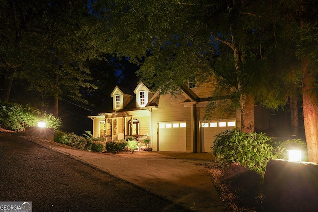 view of front of home with concrete driveway and a garage