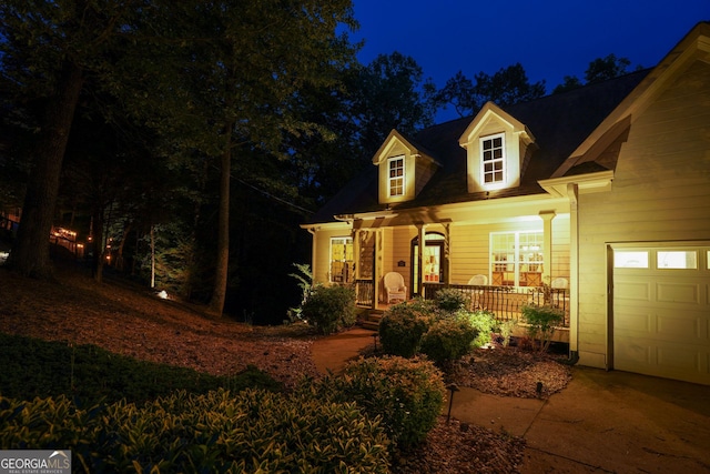 cape cod-style house featuring covered porch