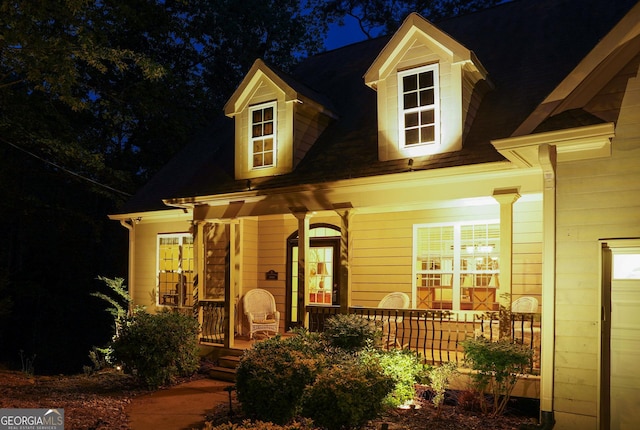 exterior entry at twilight featuring a porch