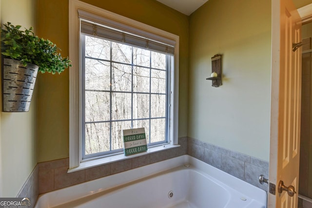 full bathroom with a whirlpool tub