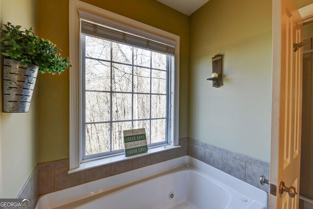 full bathroom with a jetted tub