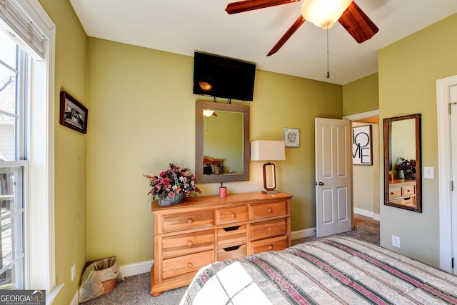 carpeted bedroom featuring baseboards and a ceiling fan