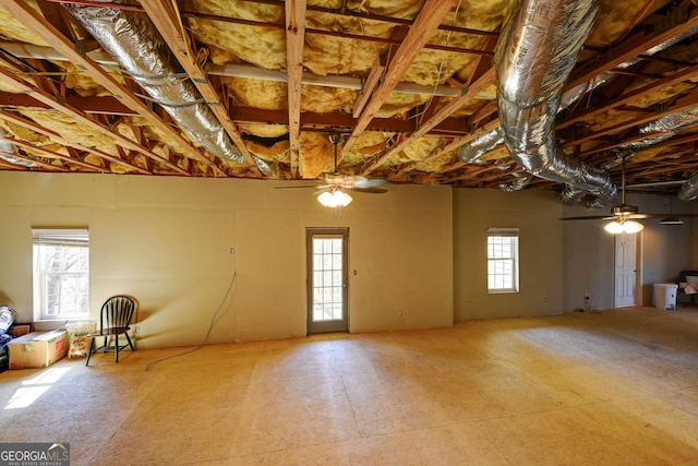 basement featuring plenty of natural light and ceiling fan