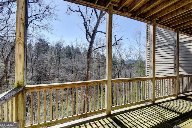 wooden terrace with a view of trees