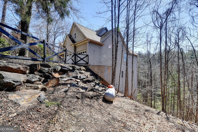 view of home's exterior featuring roof with shingles