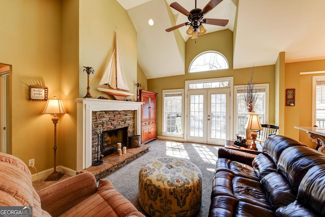 carpeted living area with high vaulted ceiling, ceiling fan, a fireplace, french doors, and baseboards