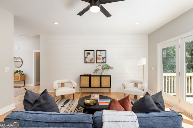 living room featuring recessed lighting, baseboards, and wood finished floors