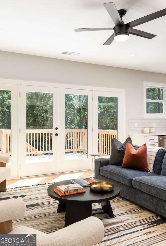 living room featuring visible vents and ceiling fan