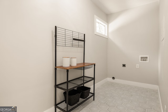 laundry room featuring baseboards, laundry area, electric dryer hookup, washer hookup, and tile patterned flooring