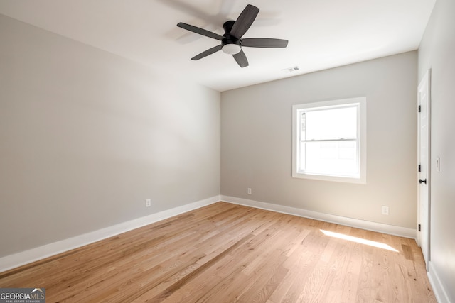 unfurnished room featuring visible vents, ceiling fan, light wood-type flooring, and baseboards