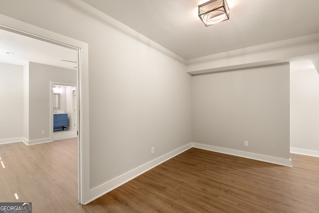 empty room with wood finished floors and baseboards