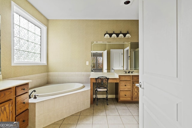 full bathroom featuring a wealth of natural light, tile patterned flooring, vanity, and a bath