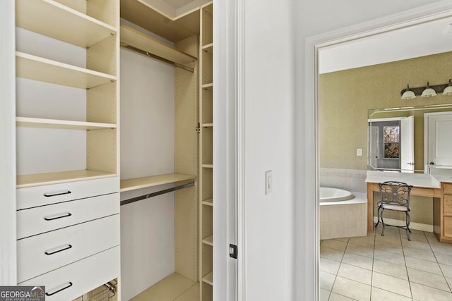 walk in closet with light tile patterned floors