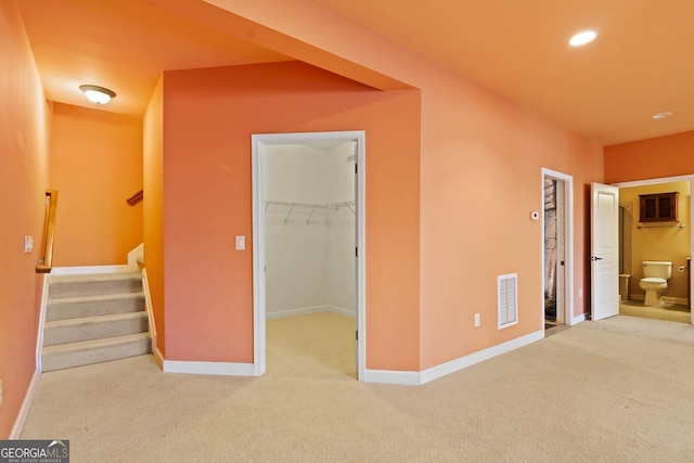 interior space featuring recessed lighting, carpet floors, visible vents, baseboards, and stairway