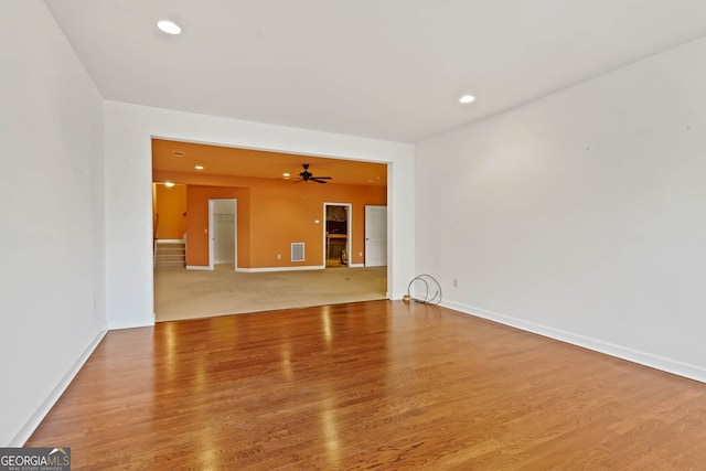 spare room featuring baseboards, wood finished floors, a ceiling fan, and recessed lighting