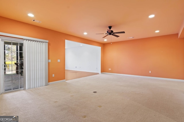 empty room featuring carpet floors, recessed lighting, visible vents, and baseboards