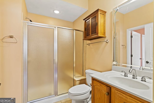 full bathroom with toilet, vanity, and a shower with door