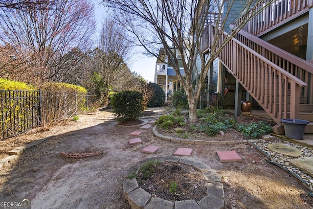 view of yard featuring fence and stairway